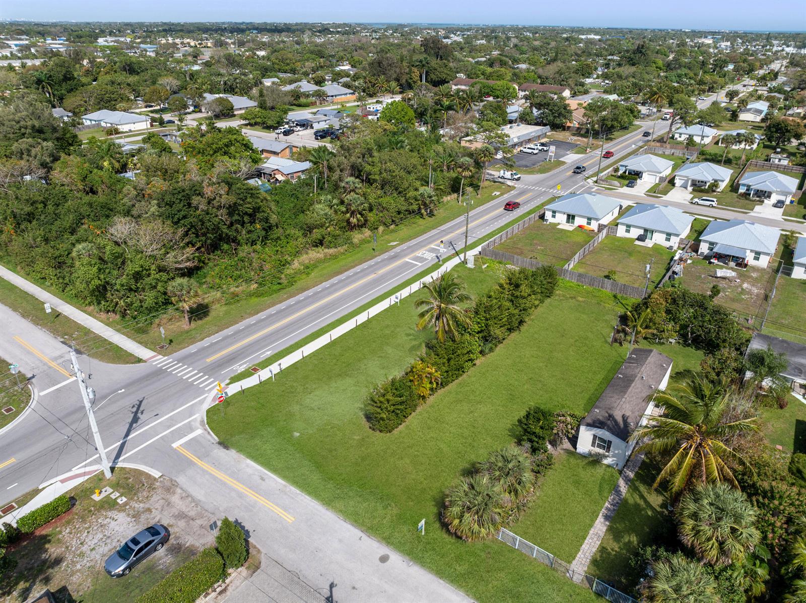 An aerial view shows a residential street intersection with a grassy lot and nearby houses — 5161 SE Kingfish Avenue, Stuart FL 34997, STUART, FL