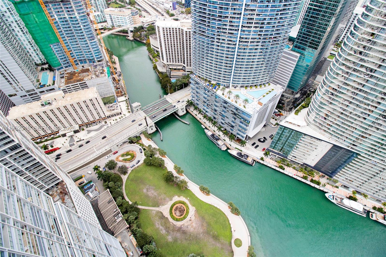 An aerial view shows a city park, a river, a bridge, and several high-rise buildings — 465 Brickell Ave # 5102, Miami FL 33131, MIAMI, FL