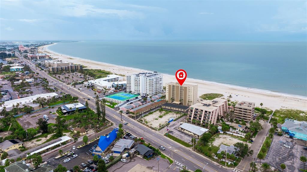 An aerial view shows a beachfront high-rise condominium building marked with a red location pin — 5000 GULF BOULEVARD UNIT 301, ST PETE BEACH, FL