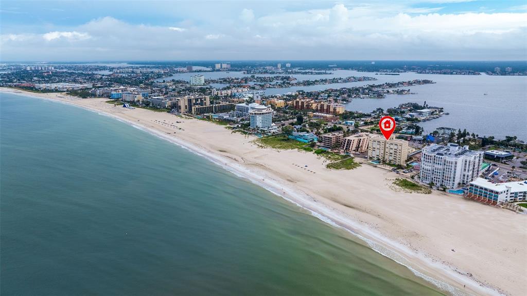 An aerial view shows a beachfront condominium building marked with a red location pin — 5000 GULF BOULEVARD UNIT 301, ST PETE BEACH, FL