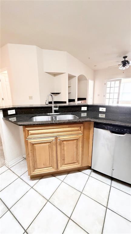 A kitchen features a dark granite countertop, a stainless steel sink, and light wood cabinets — 832 CAMARGO WAY UNIT 307, ALTAMONTE SPRINGS, FL