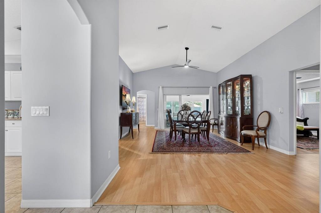 A dining area with a wooden table, chairs, and a large hutch on hardwood floors — 39 WHEELING LANE, PALM COAST, FL