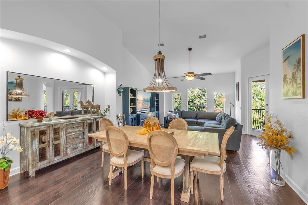 A dining area with a wooden table and chairs sits in front of a living room — 5469 46TH COURT W, BRADENTON, FL