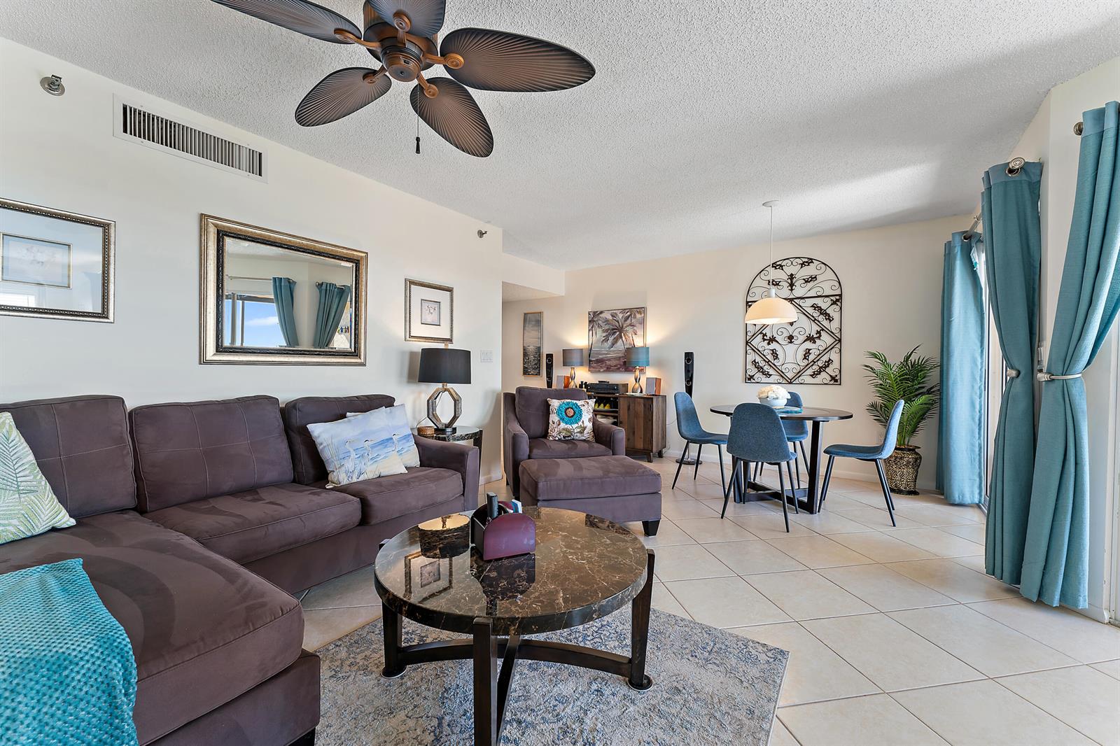 A living and dining area features a brown sectional sofa, marble coffee table, and ceiling fan — 275 Palm Avenue # C503, Jupiter FL 33477, JUPITER, FL