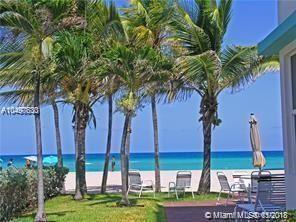 A view of a sandy beach and ocean from a patio with palm trees — 1801 S Surf Road # 2C, Hollywood FL 33019, HOLLYWOOD, FL