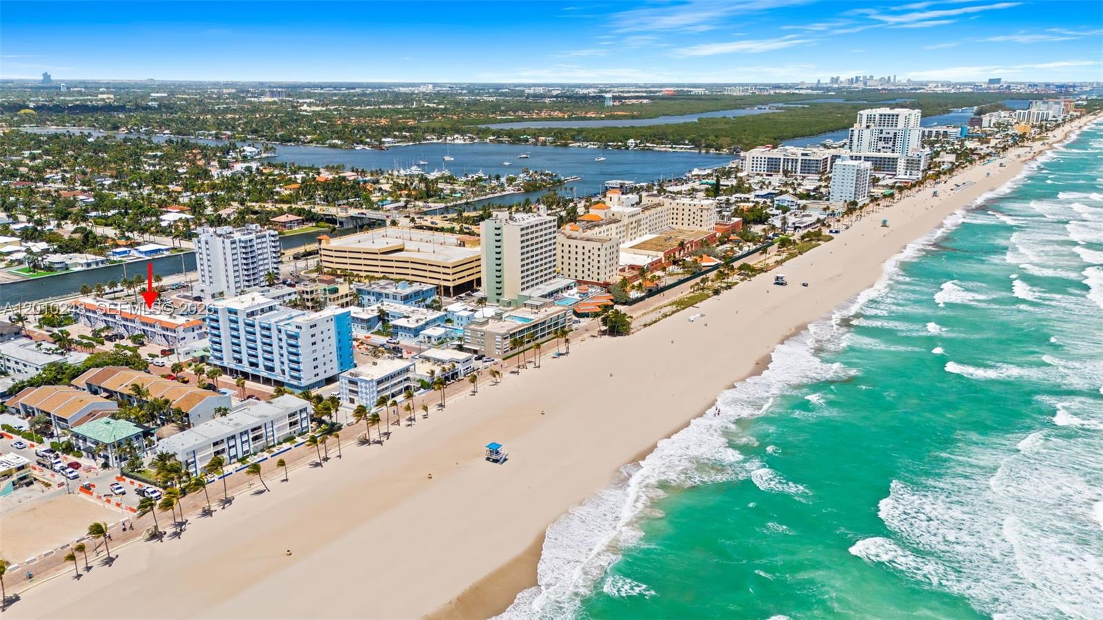 An aerial view shows a coastal beach town with high-rise buildings and ocean waves — 343 Virginia St, Hollywood FL 33019, HOLLYWOOD, FL