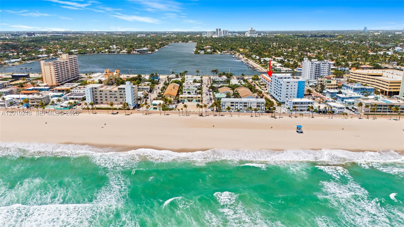 An aerial view shows a beachfront apartment building marked with a red arrow — 343 Virginia St, Hollywood FL 33019, HOLLYWOOD, FL