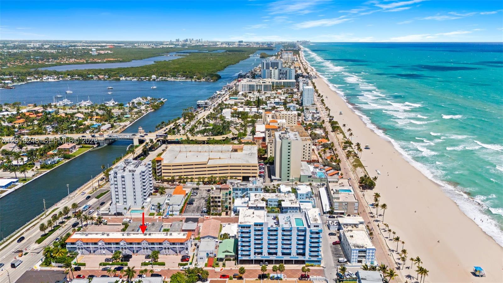An aerial view shows a coastal neighborhood with a red arrow pointing to a building — 343 Virginia St, Hollywood FL 33019, HOLLYWOOD, FL