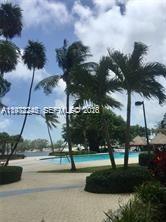A swimming pool surrounded by palm trees and a paved patio area — 2451 Brickell Ave # 4P, Miami FL 33129, MIAMI, FL