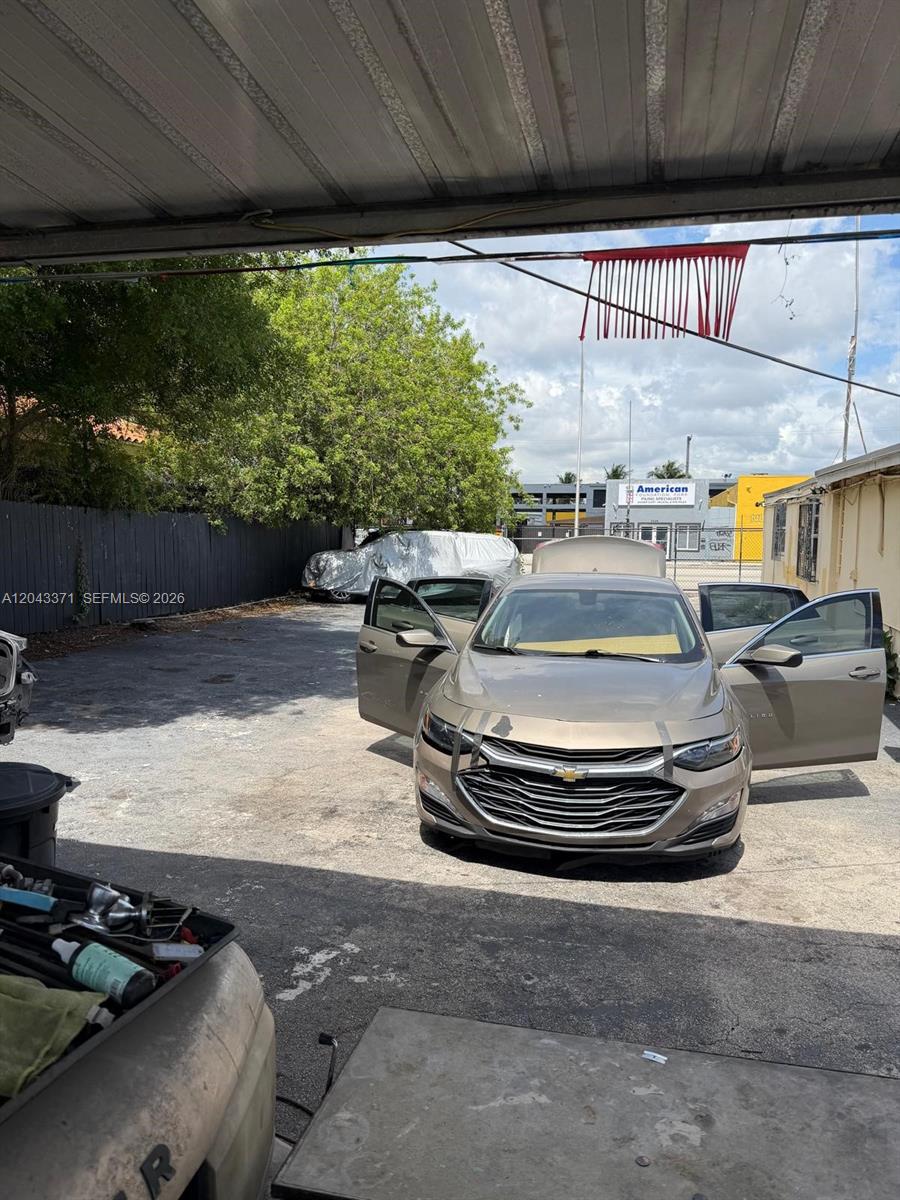 A tan sedan with an open hood and doors sits in a paved outdoor lot — 3445 NW 27th Ave, Miami FL 33142, MIAMI, FL