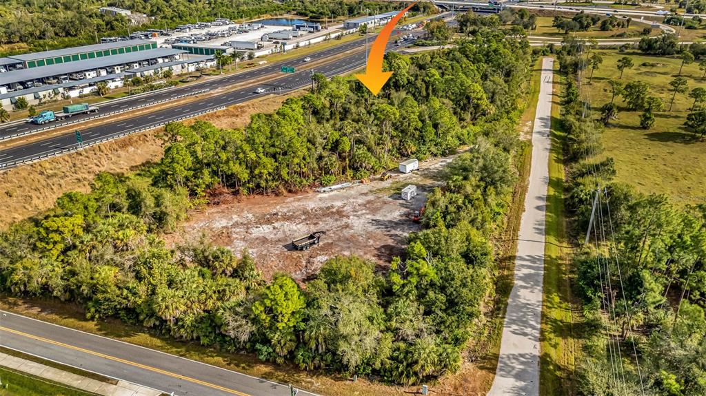 An aerial view shows a cleared lot surrounded by trees next to a highway — Unnamed US17 I75 EXIT 164 STREET, PUNTA GORDA, FL