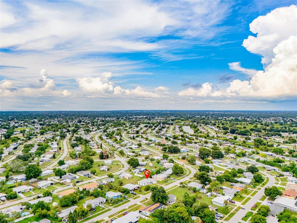 An aerial view shows a residential neighborhood with a red pin marking a specific house — 21928 BEVERLY AVENUE, PORT CHARLOTTE, FL