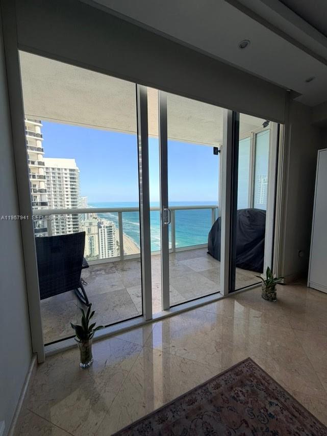A room with marble floors and sliding glass doors opening to a balcony overlooking the ocean — 1830 S Ocean Dr # 3810, Hallandale Beach FL 33009, HALLANDALE BEACH, FL