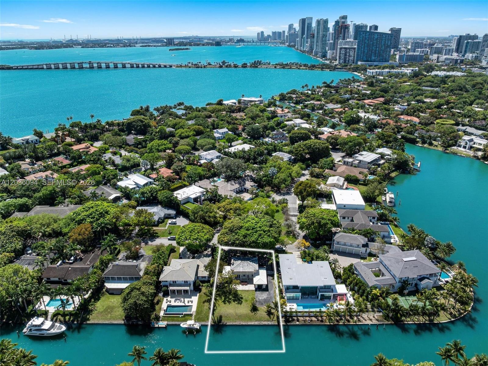 An aerial view shows a waterfront house with a white outline on a canal — 655 Buttonwood Ln, Miami FL 33137, MIAMI, FL