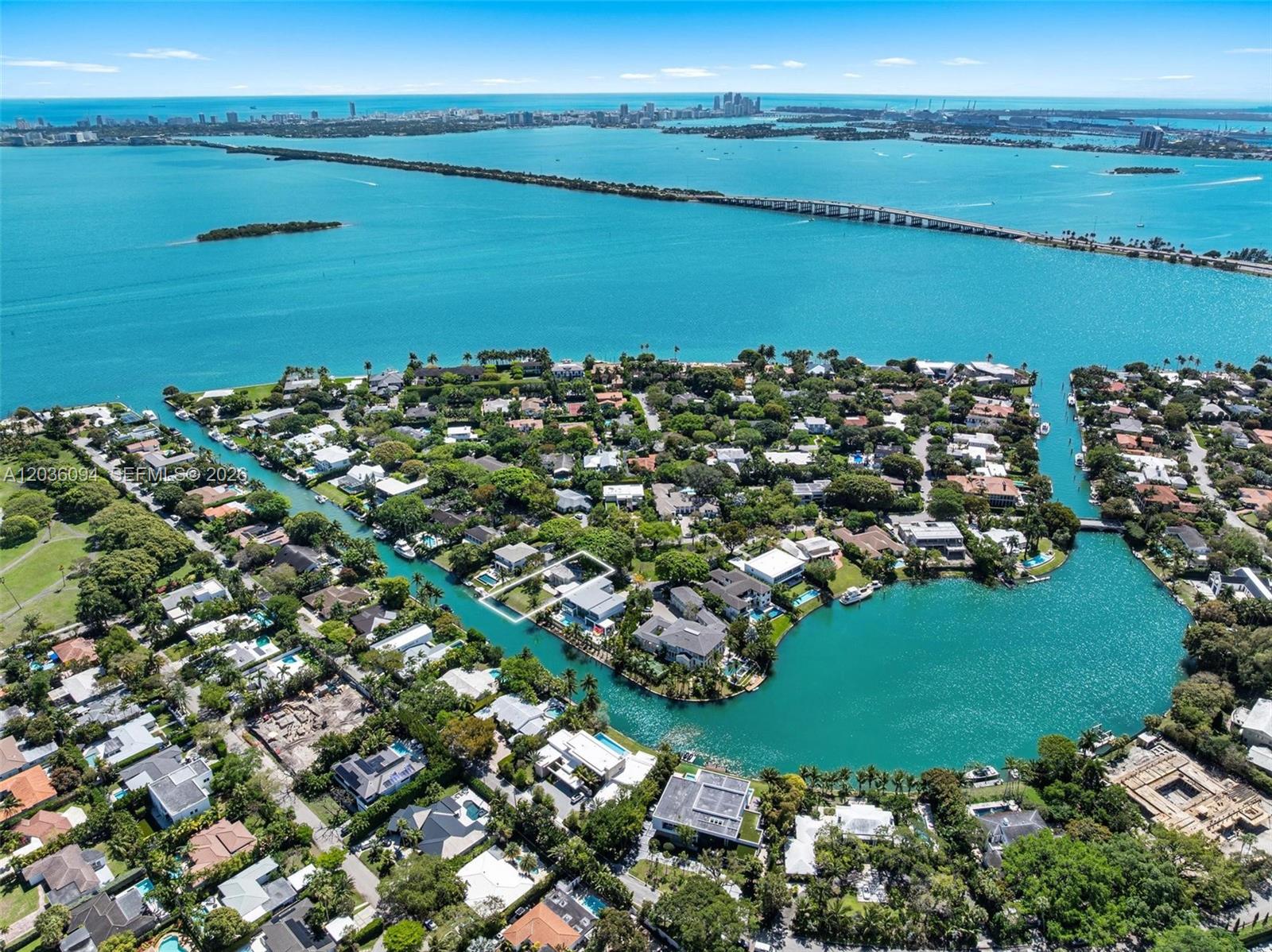 An aerial view shows a waterfront residential neighborhood with a highlighted property on a canal — 655 Buttonwood Ln, Miami FL 33137, MIAMI, FL