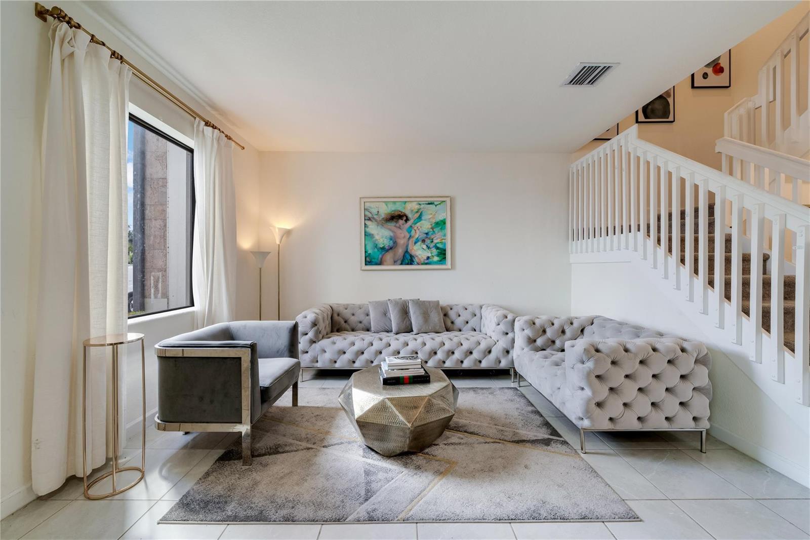 The exterior of a two-story townhouse features a stone-accented entryway with a hanging chair — 11392 W 34th Way, Hialeah FL 33018, HIALEAH, FL