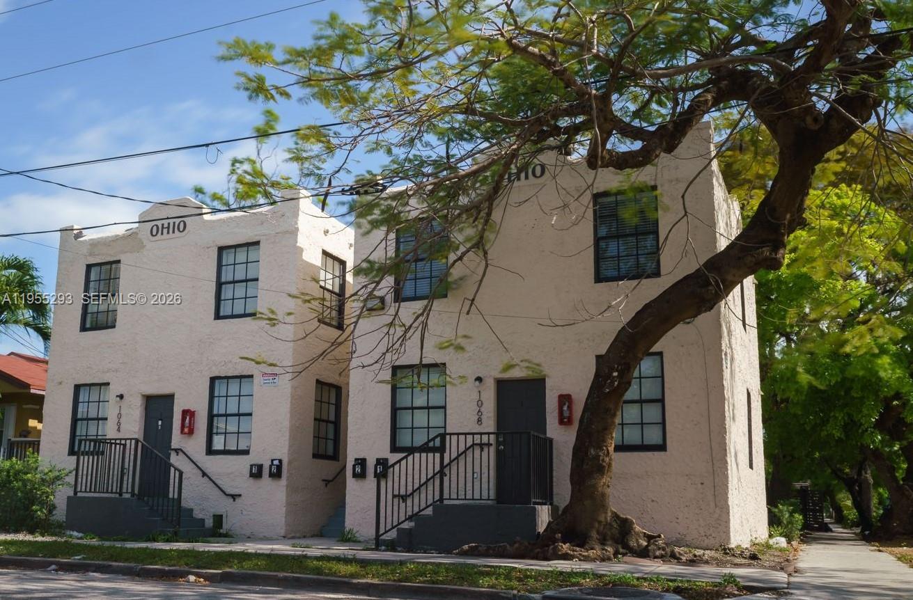 A two-story stucco apartment building features the word OHIO on its facade and exterior stairs — 1068 NW 5th St, Miami FL 33128, MIAMI, FL