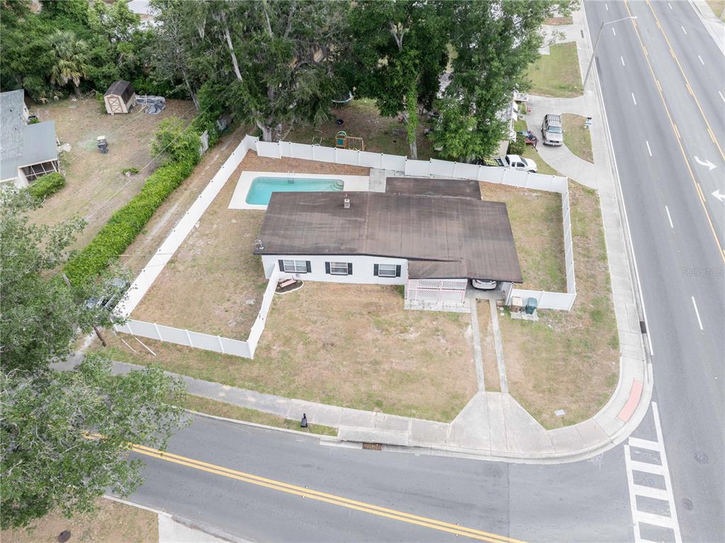 An aerial view shows a single-story house with a pool and fenced yard on a corner — 3523 SE 6TH STREET, OCALA, FL