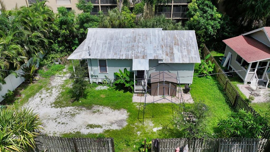 A yellow, single-story house with a screened-in front porch and brick steps — 1569 7TH STREET, SARASOTA, FL