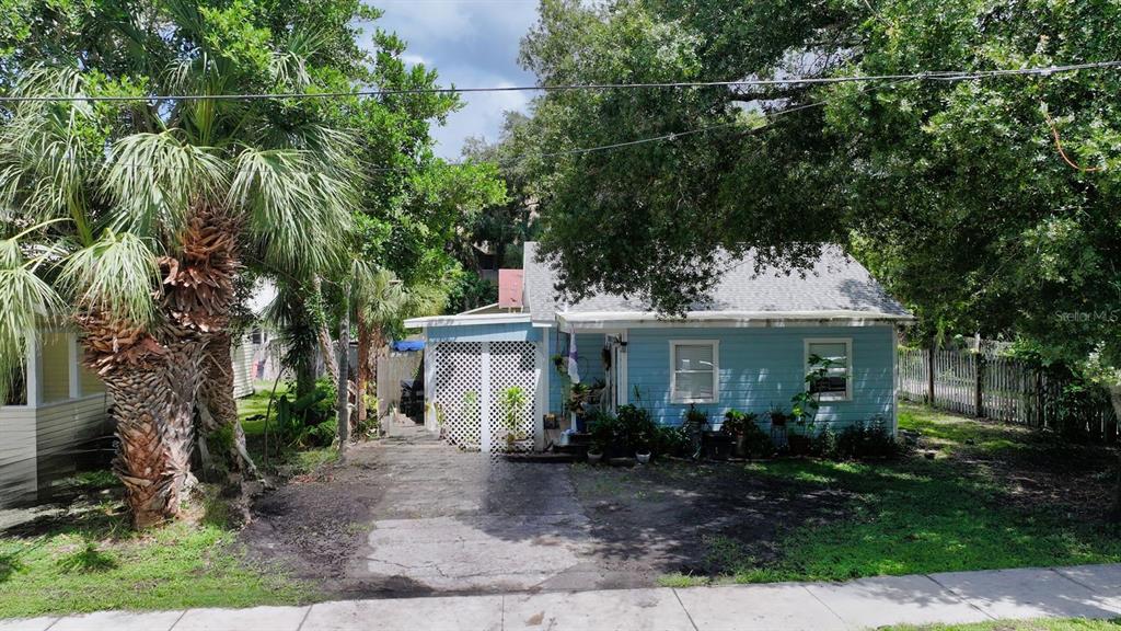 An empty room with hardwood floors, a ceiling fan, and a red-framed glass door — 1569 7TH STREET, SARASOTA, FL
