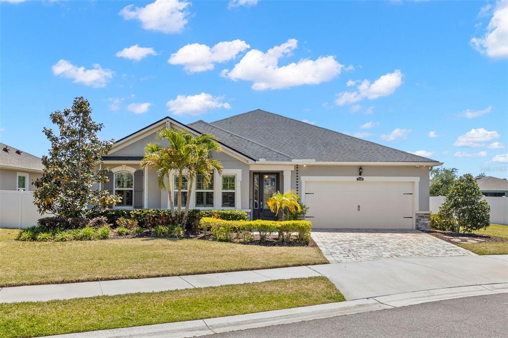 A single-story house with a gray exterior, a two-car garage, and a paved driveway — 12109 NIGHT JASMINE COVE, RIVERVIEW, FL