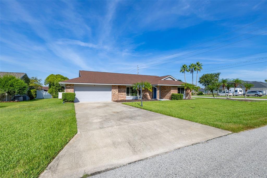 A single-story brick house with a brown roof and a concrete driveway — 2 CLAYMONT COURT S, PALM COAST, FL