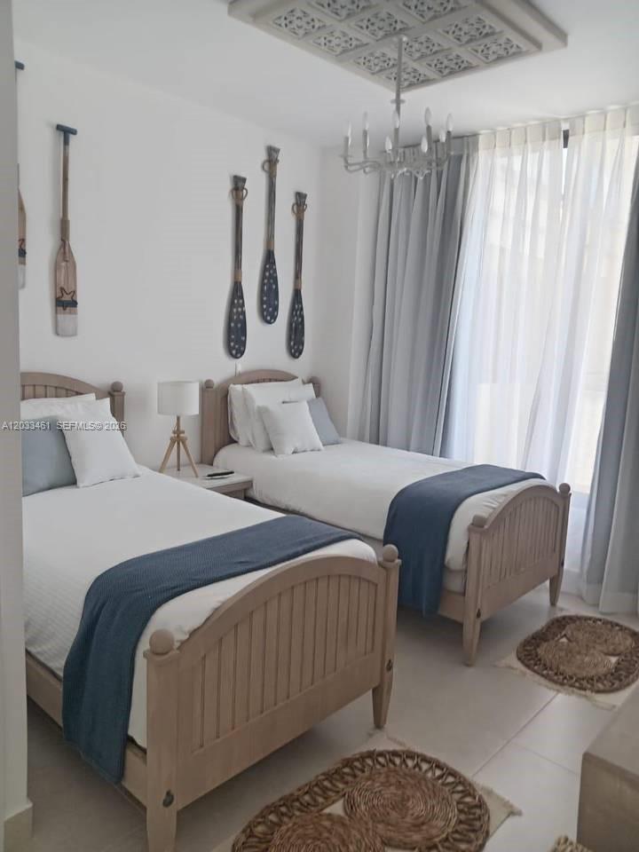 A bedroom features two twin beds with light wood frames and nautical oar wall decor — 1 1 # 205, FL, FL