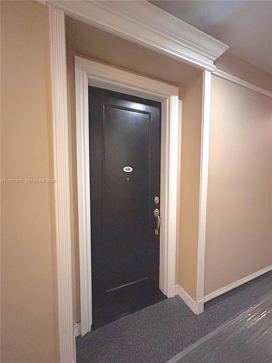 A dark brown door with the number 626 is set within a white-trimmed entryway — 1805 Ponce De Leon Blvd # 626, Coral Gables FL 33134, CORAL GABLES, FL