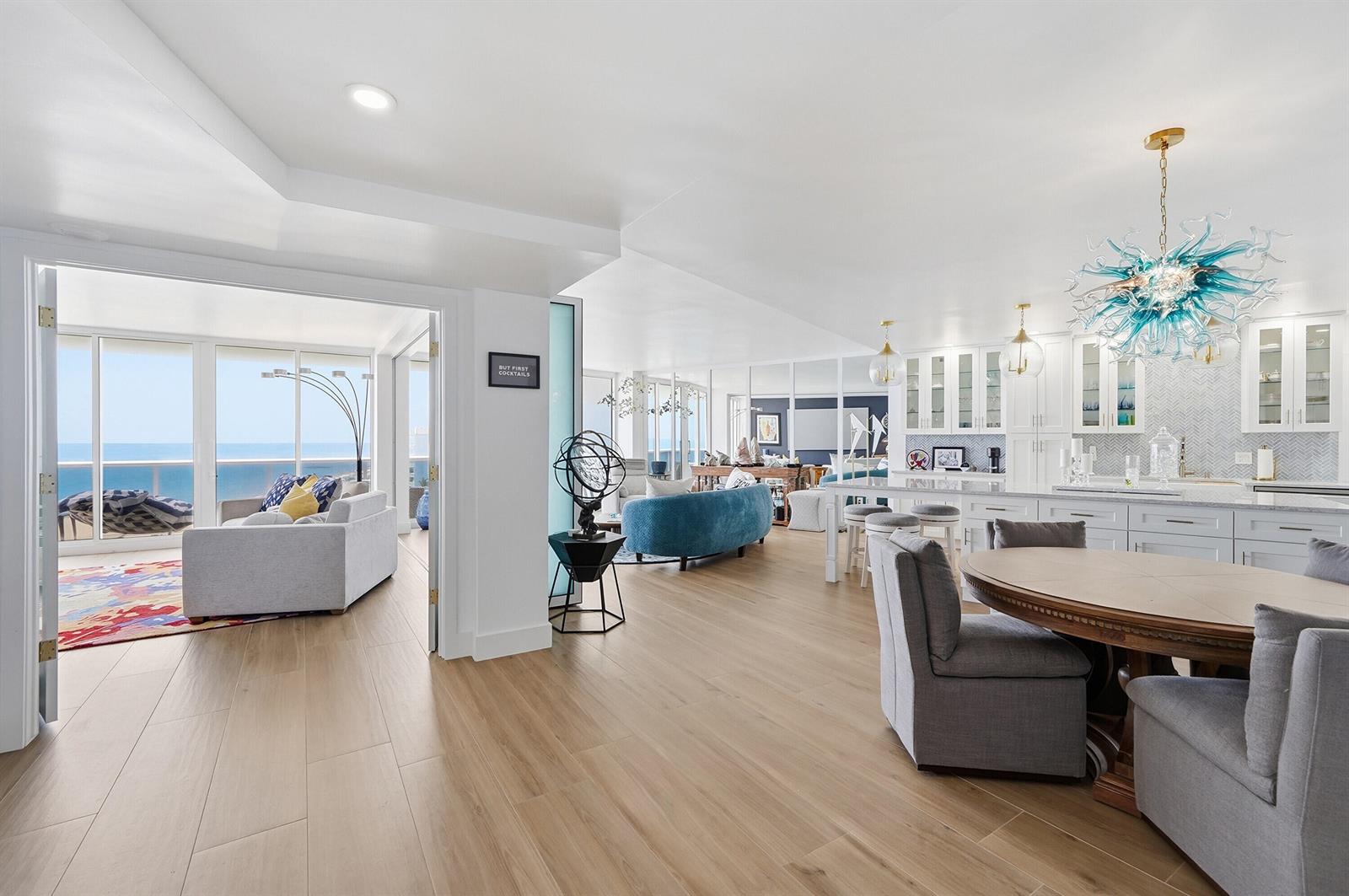 An open-concept living area features light wood floors, a modern kitchen, and ocean views — 700 S Ocean Boulevard # 803, Boca Raton FL 33432, BOCA RATON, FL
