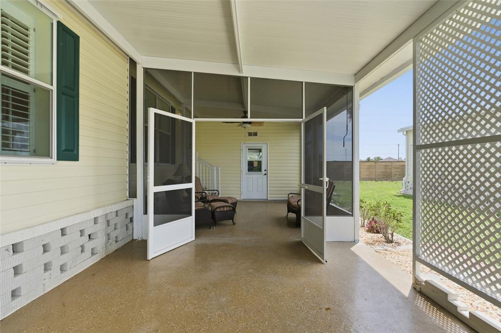 A covered patio with a concrete floor, screen doors, and outdoor furniture — 15550 BURNT STORE ROAD UNIT 30, PUNTA GORDA, FL