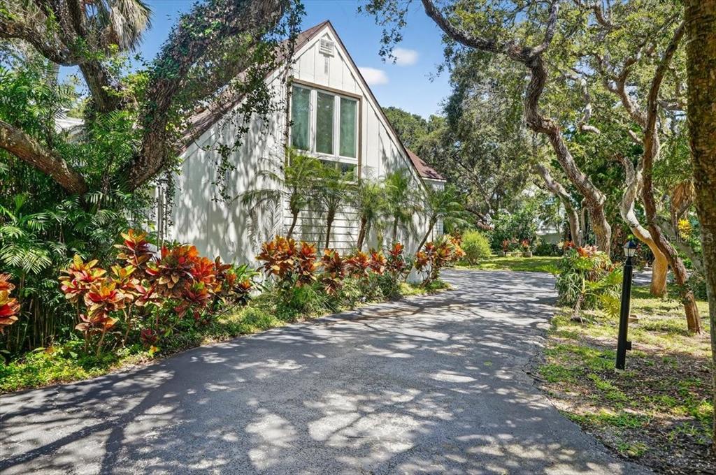 A white house with a steep roof sits at the end of a paved driveway — 120 BEACH STREET, PONCE INLET, FL