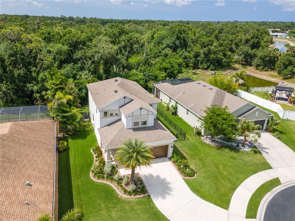 An aerial view of a two-story suburban house with a driveway and a backyard pool — 6311 HORSE MILL PLACE, PALMETTO, FL