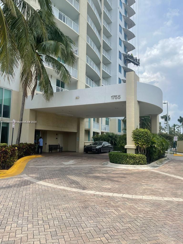 A paved driveway leads to the covered entrance of a high-rise residential building — 1755 E Hallandale Beach Blvd, Hallandale Beach FL 33009, HALLANDALE BEACH, FL