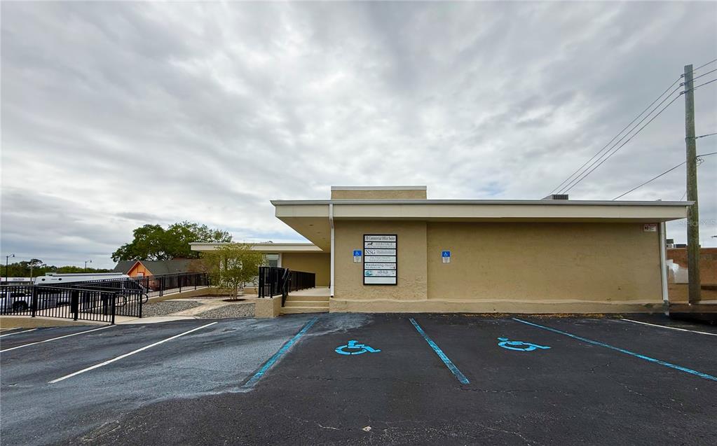 A single-story commercial building with a parking lot featuring two handicap-accessible spaces — 220 CORAL SANDS DRIVE, ROCKLEDGE, FL