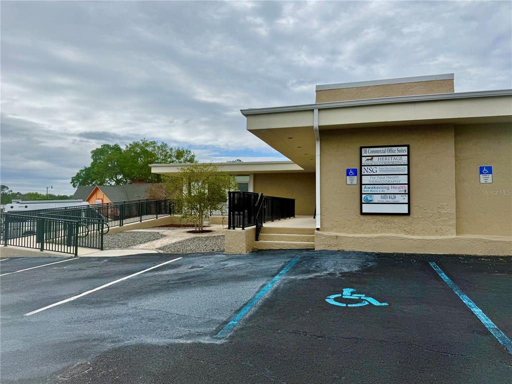 An exterior view of a commercial office building with a handicap-accessible ramp and parking — 220 CORAL SANDS DRIVE, ROCKLEDGE, FL