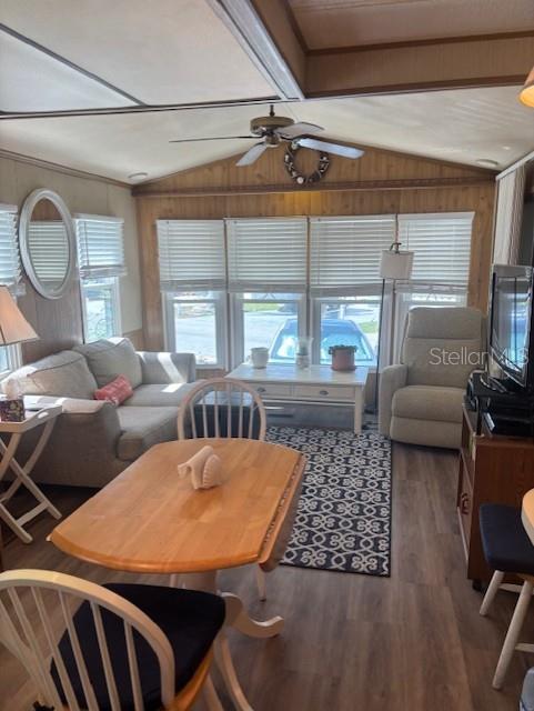 A living room features a sofa, dining table, recliner, and large windows with white blinds — 9000 US HWY 192 UNIT 381, CLERMONT, FL