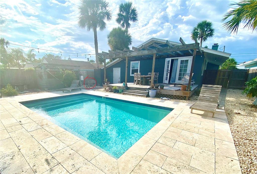 A backyard features a swimming pool, a wooden deck with a pergola, and palm trees — 207 Kirkland ROAD, NEW SMYRNA BEACH, FL