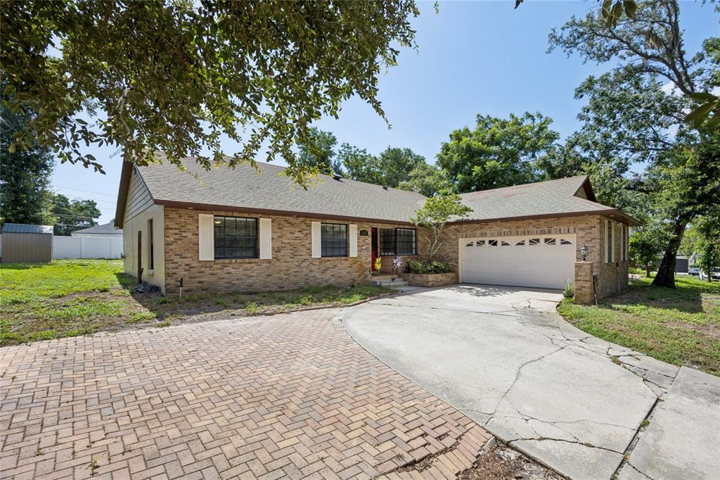 A single-story brick house with a paved driveway and a two-car garage — 733 SAXBY AVENUE, ORLANDO, FL
