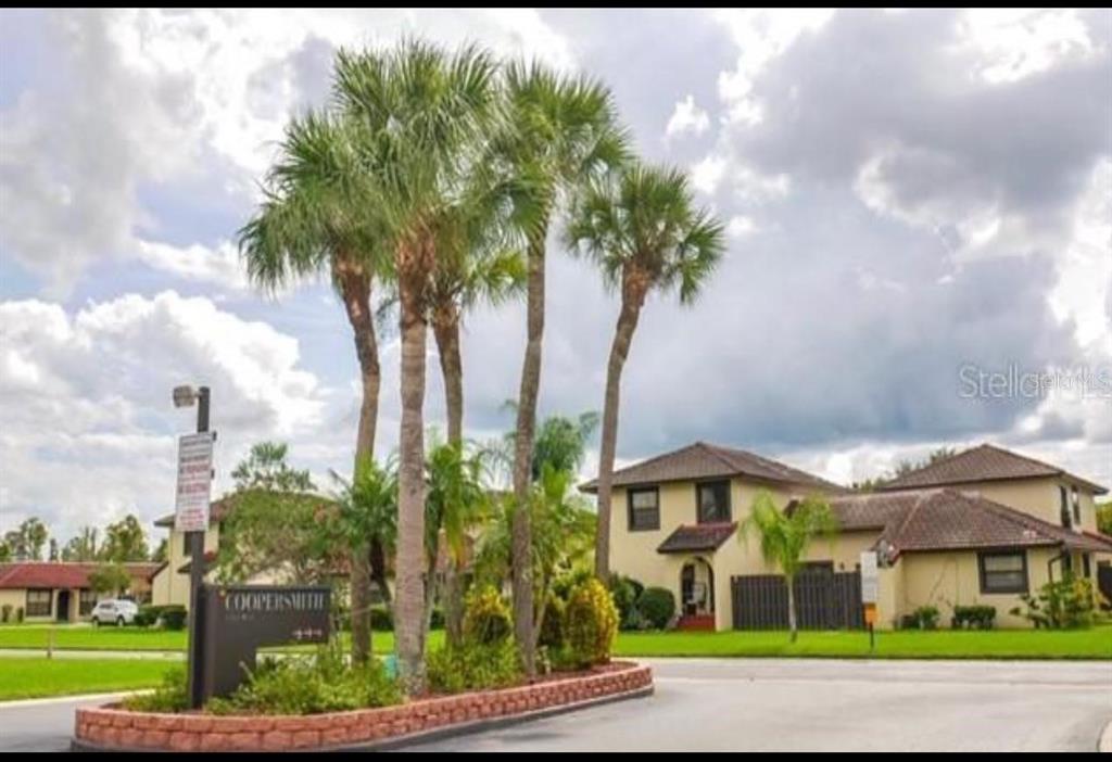 A sign for Coopersmith stands in front of palm trees and a multi-unit residential building — 437 HUNTER CIRCLE, KISSIMMEE, FL