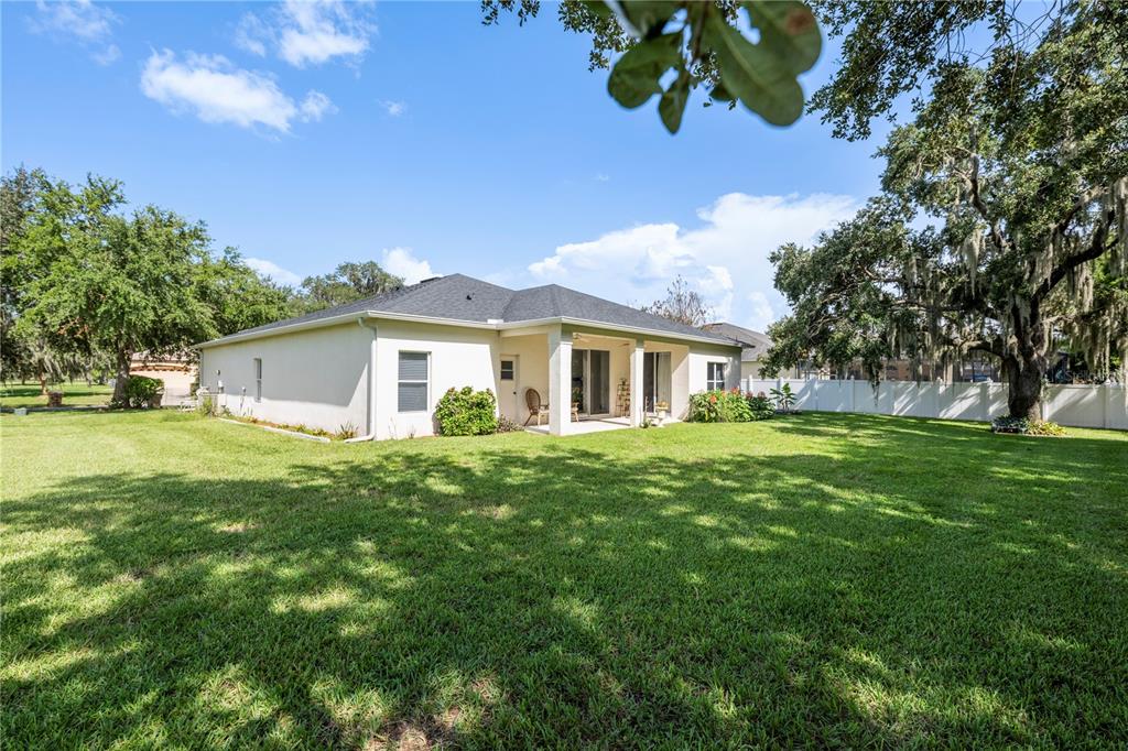 A single-story house with a beige exterior, a two-car garage, and a manicured front lawn — 3192 WATERBRIDGE LANE, KISSIMMEE, FL