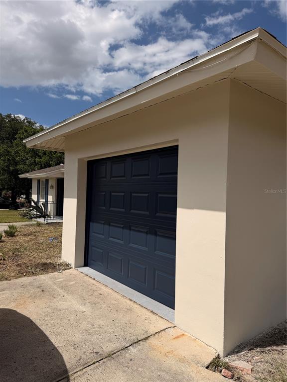 The front entrance of a house features a dark door, side windows, and black railings — 2011 KEYES LANE, DELTONA, FL