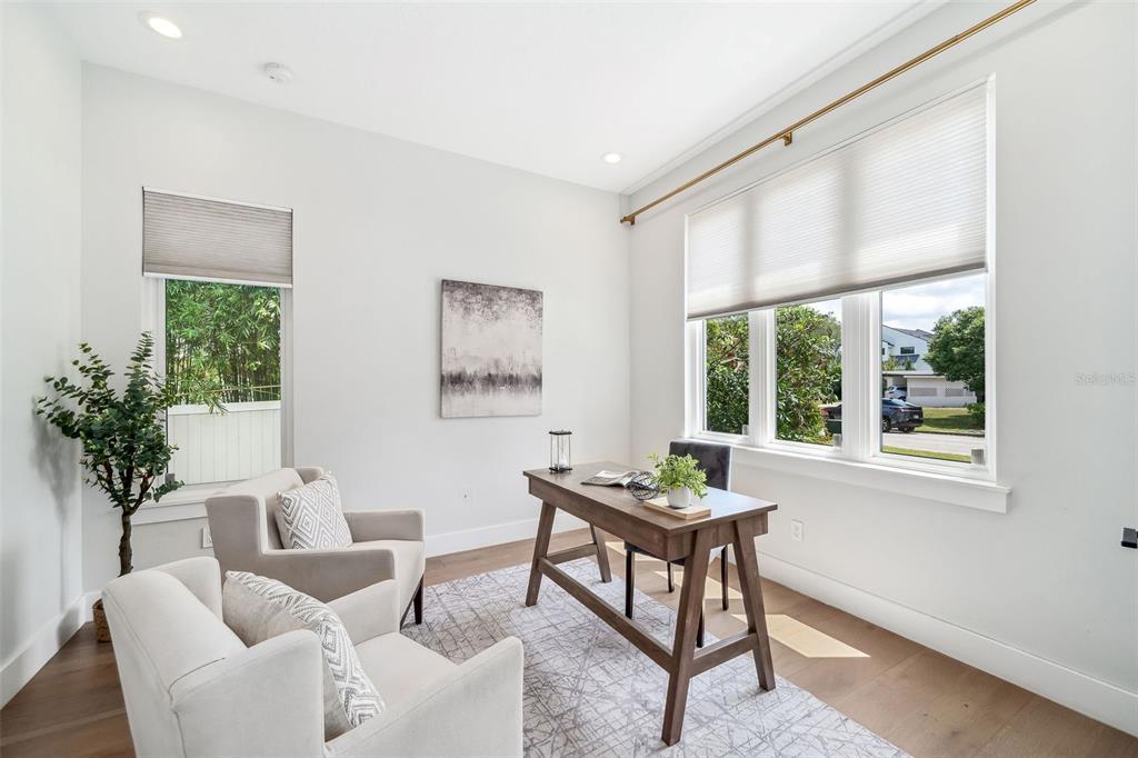 A home office features a wooden desk, two armchairs, and large windows with light shades — 2407 LAFAYETTE AVENUE, WINTER PARK, FL