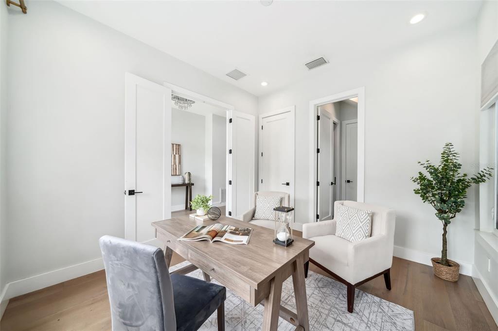 A home office features a wooden desk, two chairs, and light wood flooring — 2407 LAFAYETTE AVENUE, WINTER PARK, FL