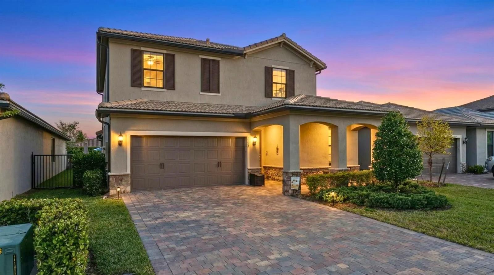 A two-story house with a paved driveway, a two-car garage, and a covered front porch — 8623 Patron Lane, Lake Worth FL 33467, LAKE WORTH, FL