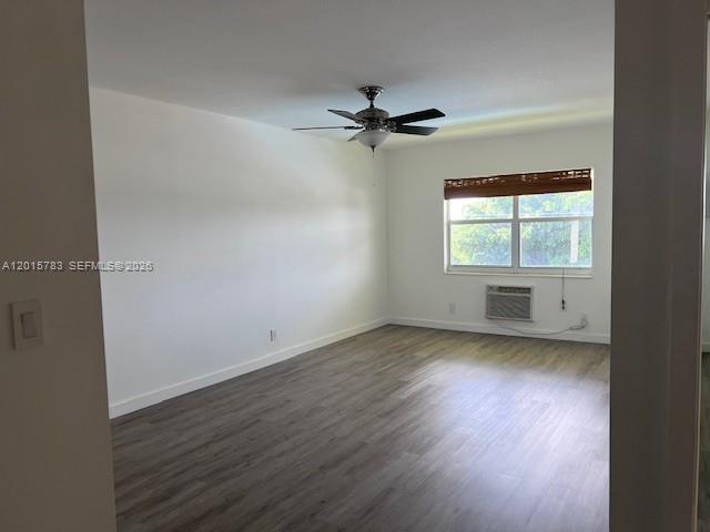 An empty room features light wood-look flooring, a ceiling fan, and a window with blinds — 1350 E Sample Rd # 306, Pompano Beach FL 33064, POMPANO BEACH, FL