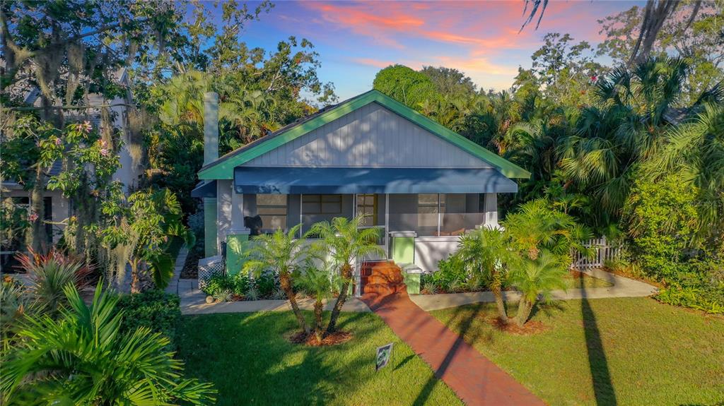 A single-story house with a screened front porch, green trim, and a red walkway — 2758 10TH STREET N, ST PETERSBURG, FL