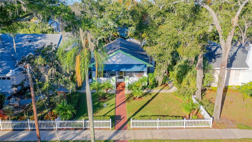 An aerial view of a single-story house with a front porch and white picket fence — 2758 10TH STREET N, ST PETERSBURG, FL