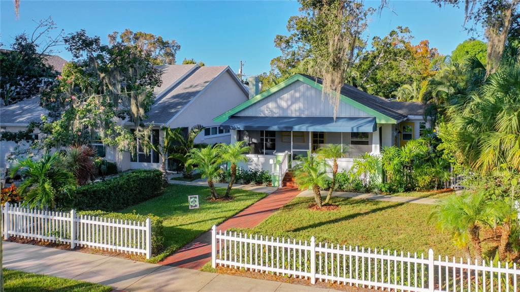 A white picket fence surrounds the front yard of two adjacent single-story houses — 2758 10TH STREET N, ST PETERSBURG, FL