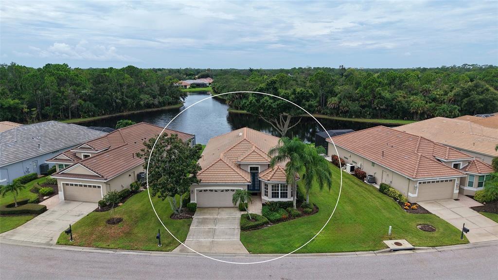 An aerial view of a single-story house with a tiled roof and a two-car garage — 8224 NICE WAY, SARASOTA, FL