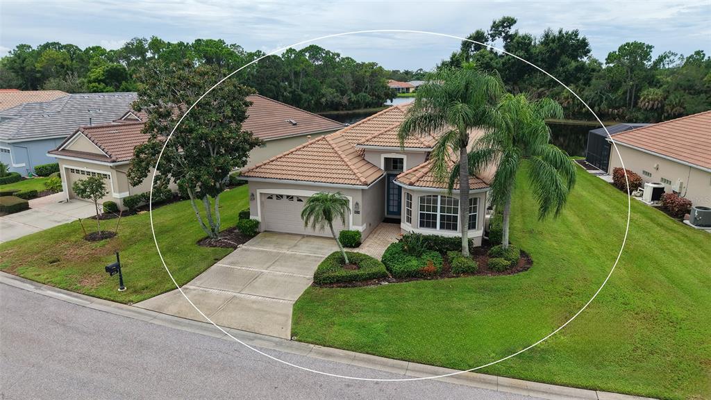 An aerial view of a single-story house with a tile roof and a palm tree — 8224 NICE WAY, SARASOTA, FL